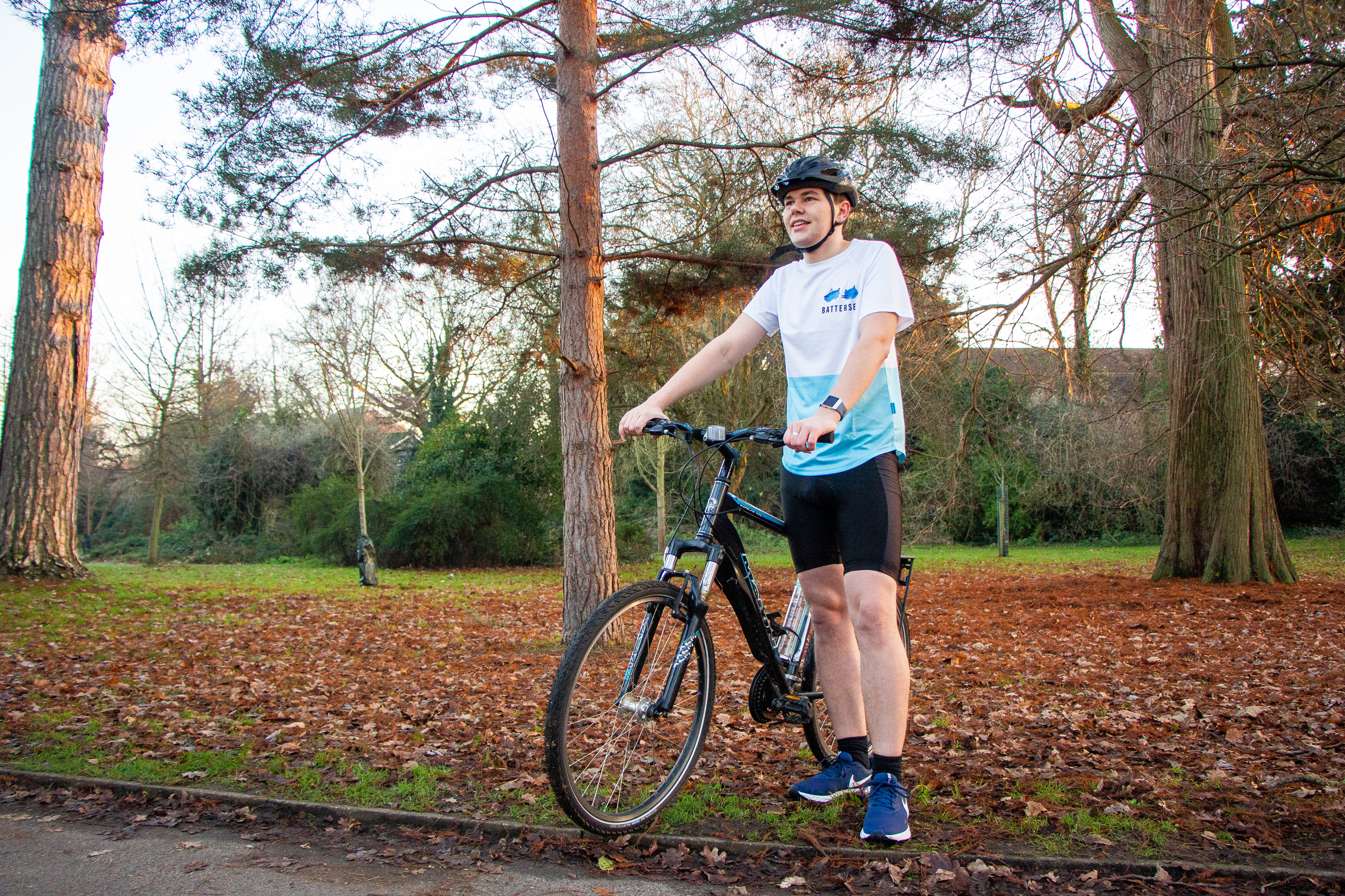 Man in Battersea fundraising top with his bike in the park